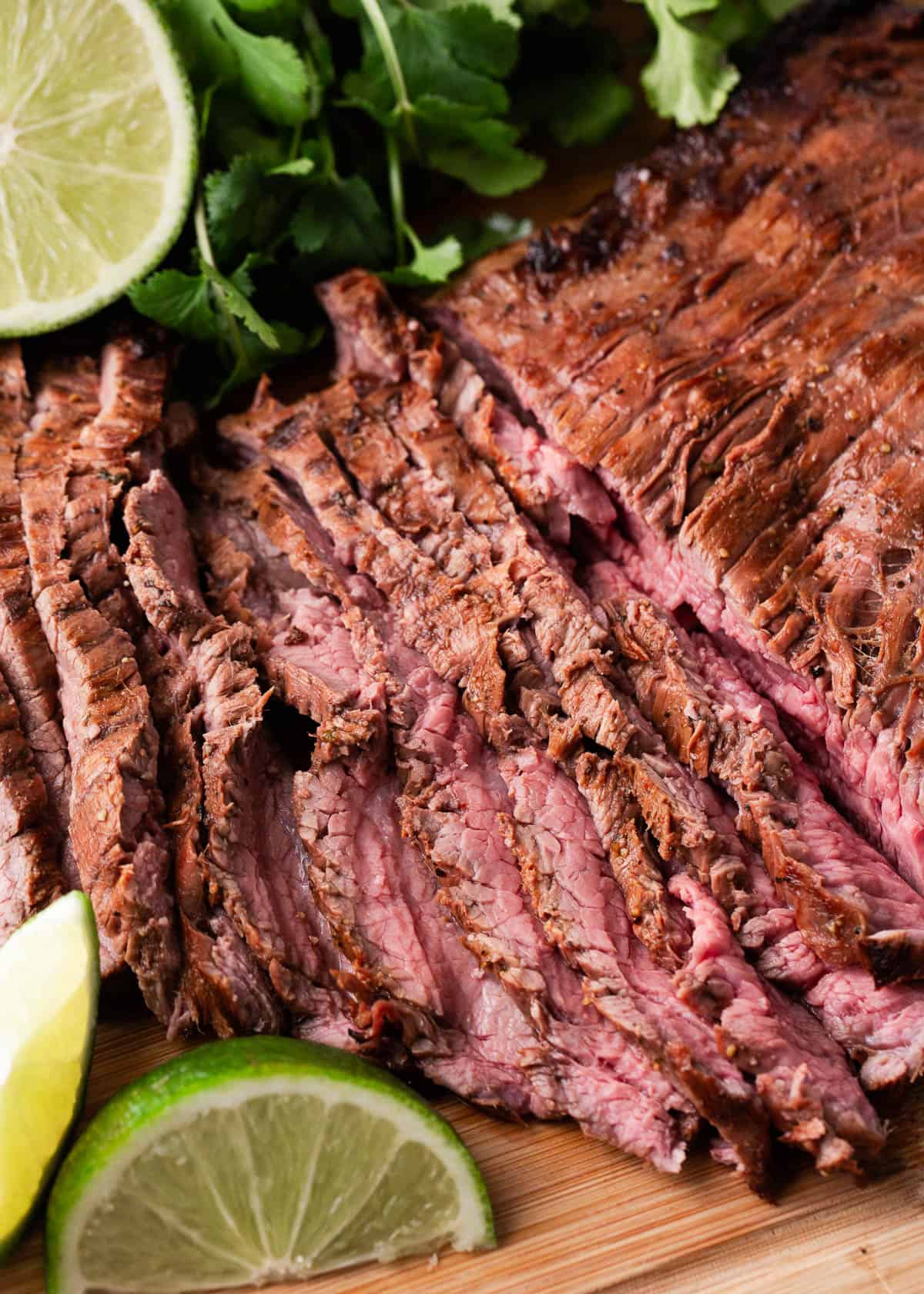 Sliced carne asada on a platter.