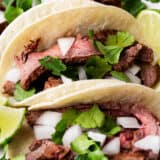 Carne asada tacos with onions and cilantro.
