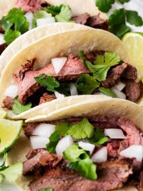 Carne asada tacos with onions and cilantro.