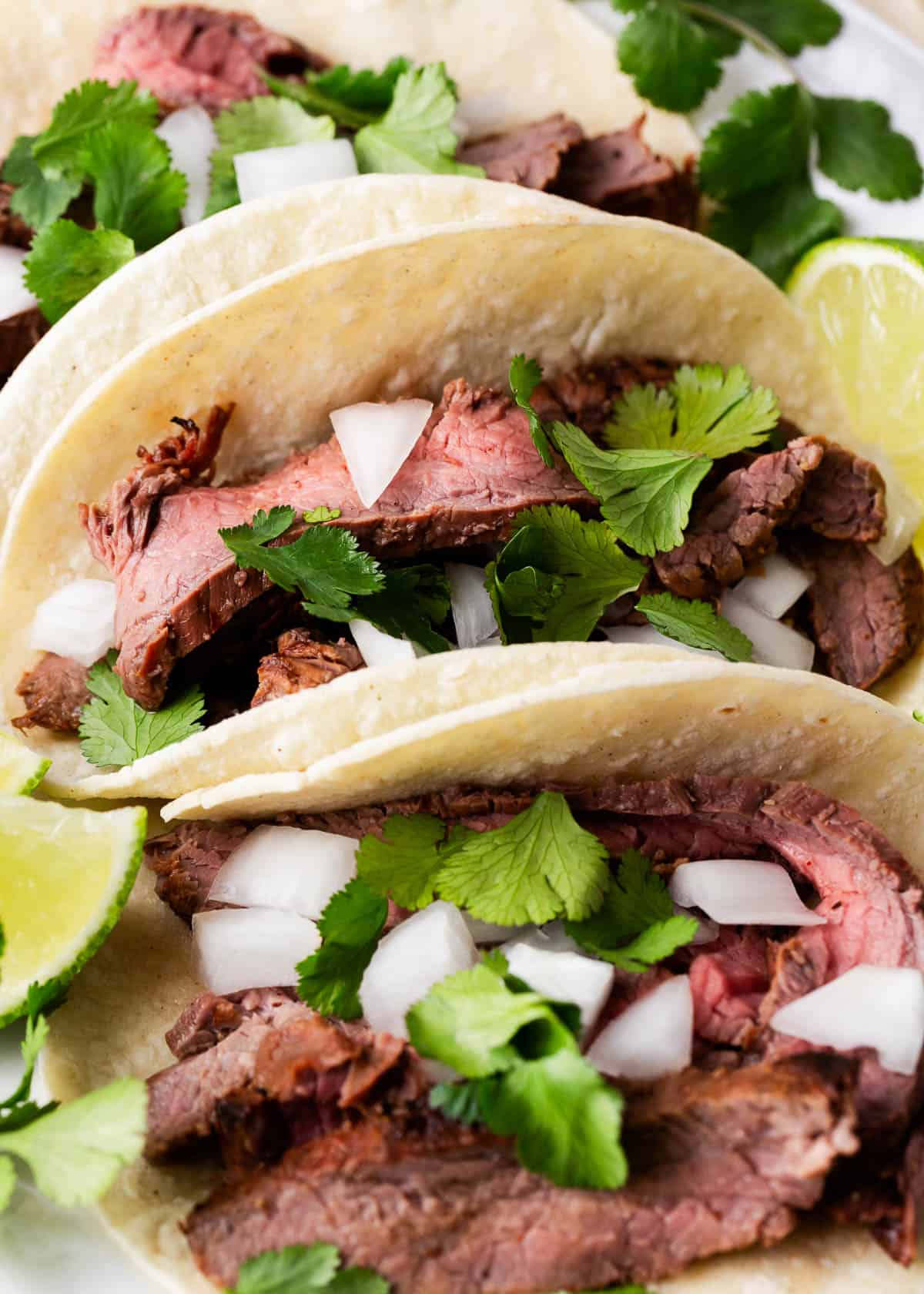 Carne asada tacos with onions and cilantro.
