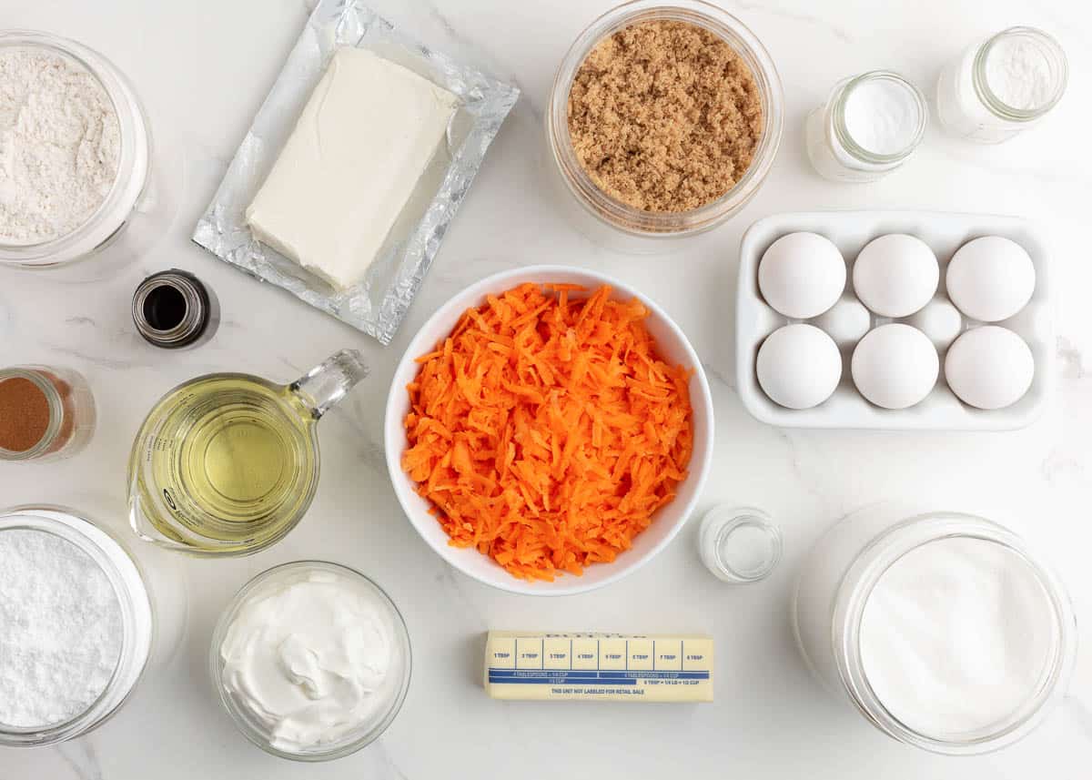 The ingredients in bowls separated for carrot cake cupcakes. 