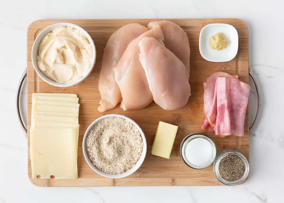 Chicken cordon bleu ingredients on a board.