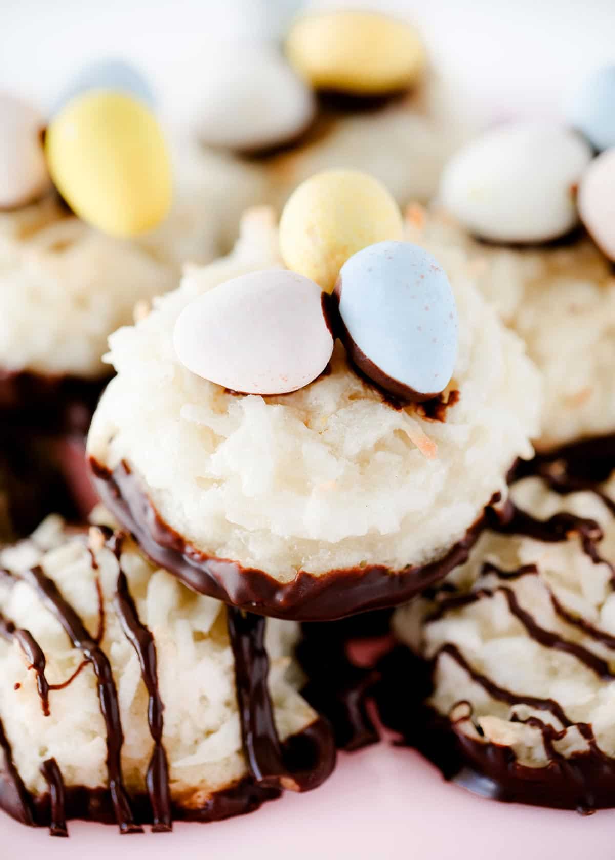 Coconut macaroons decorated like nests with Candy coat eggs on top.