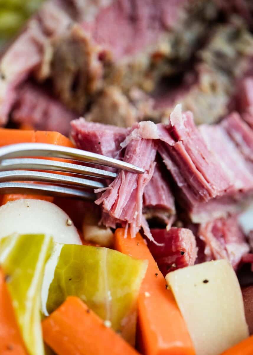 Corned beef and cabbage on fork.