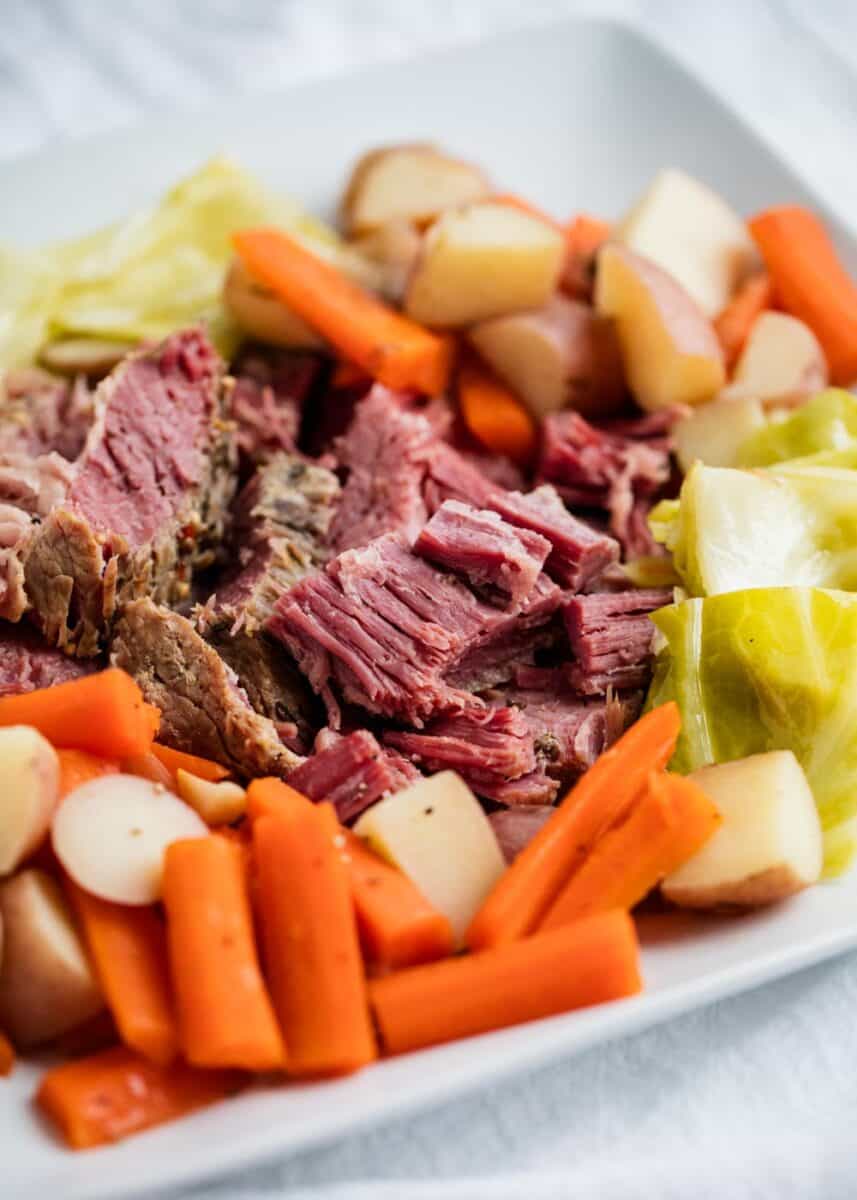 Corned beef and cabbage on a white plate.
