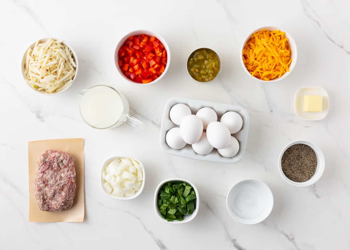 Breakfast casserole ingredients on marble counter.