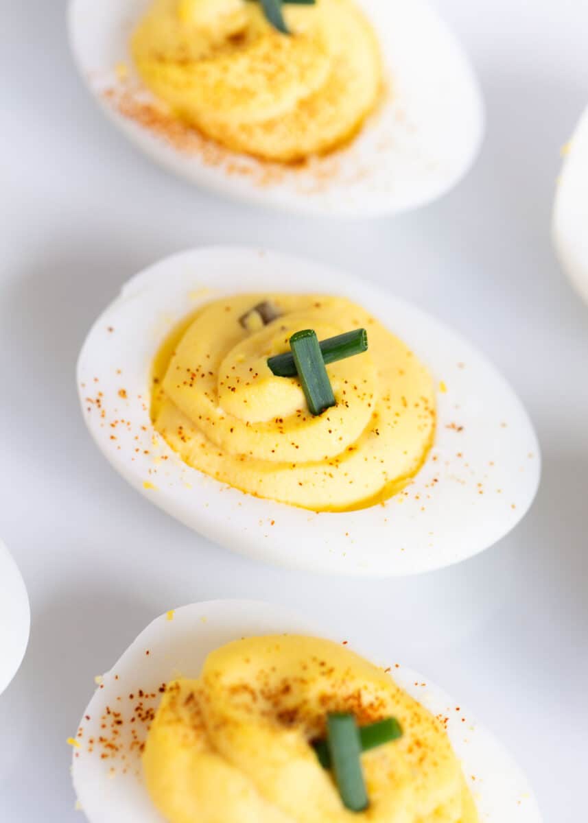 Deviled eggs on a white plate.