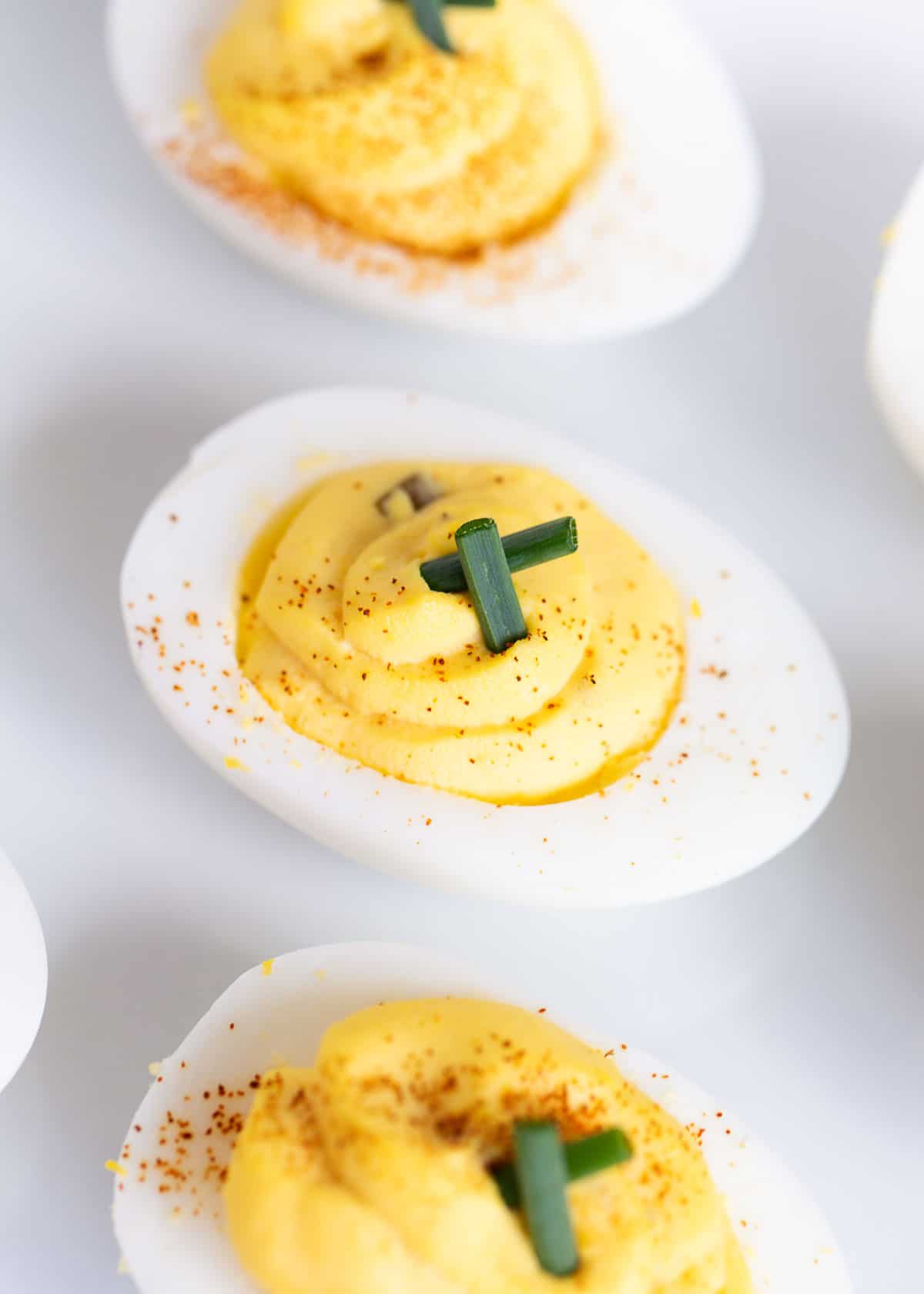 Deviled eggs on a white plate.