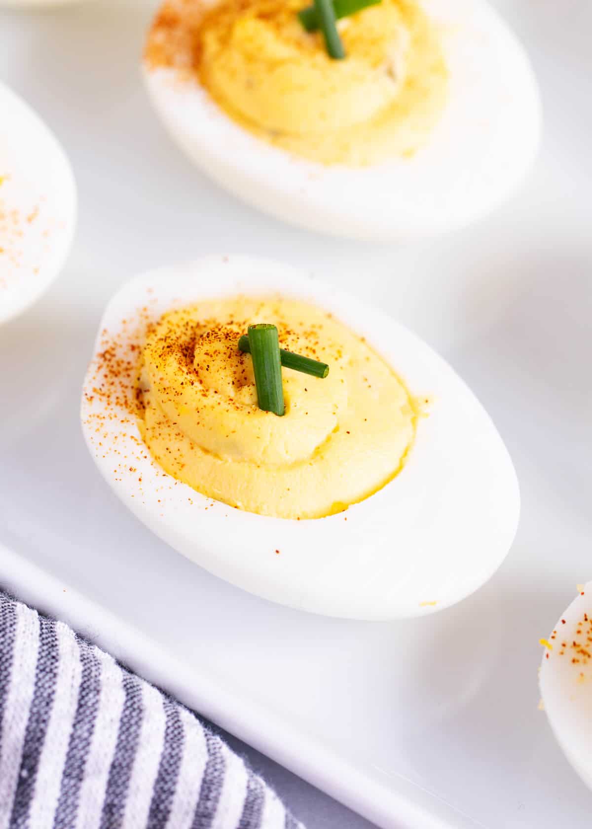 Deviled eggs on a white plate.