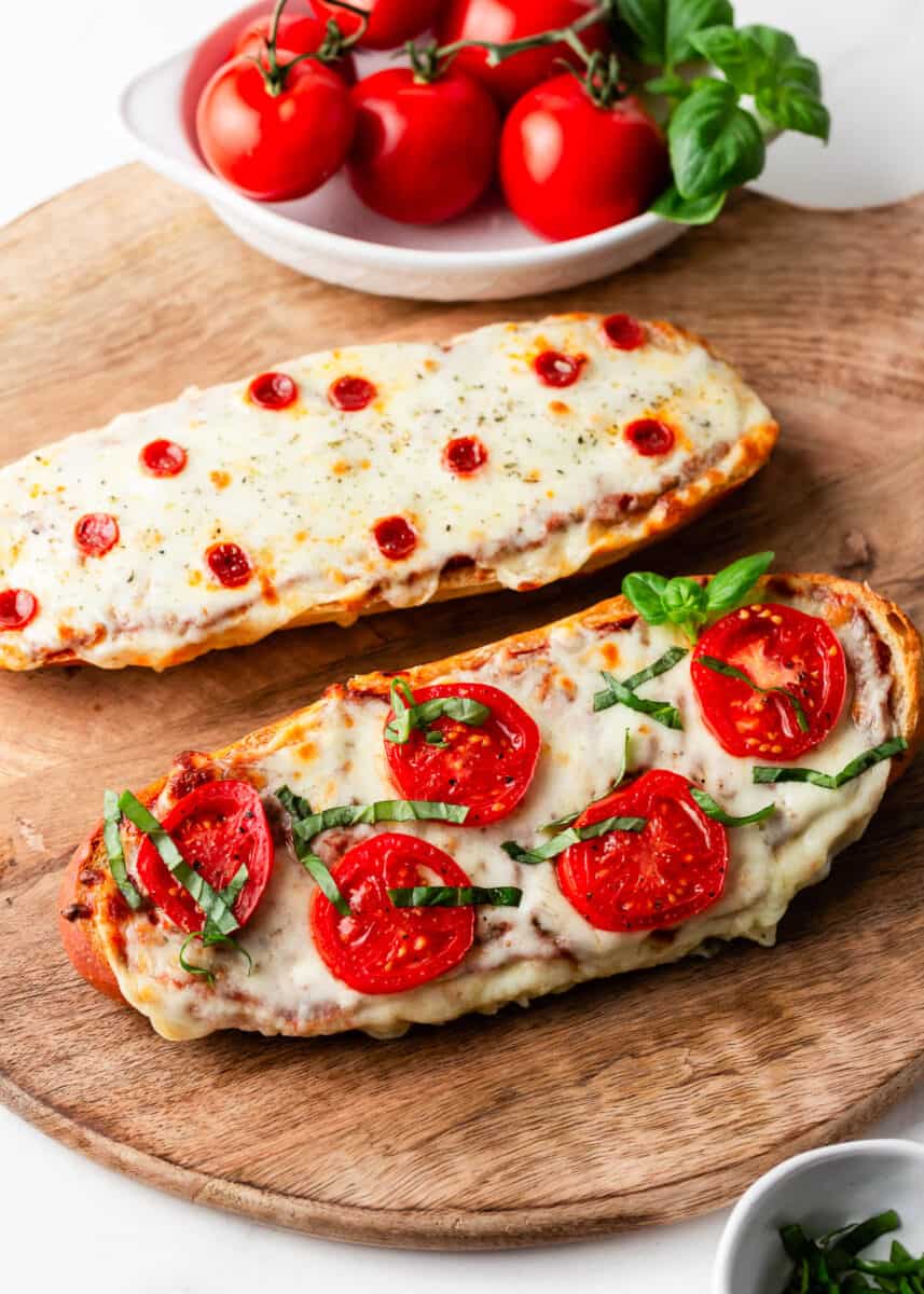 French bread pizza on a wooden board.