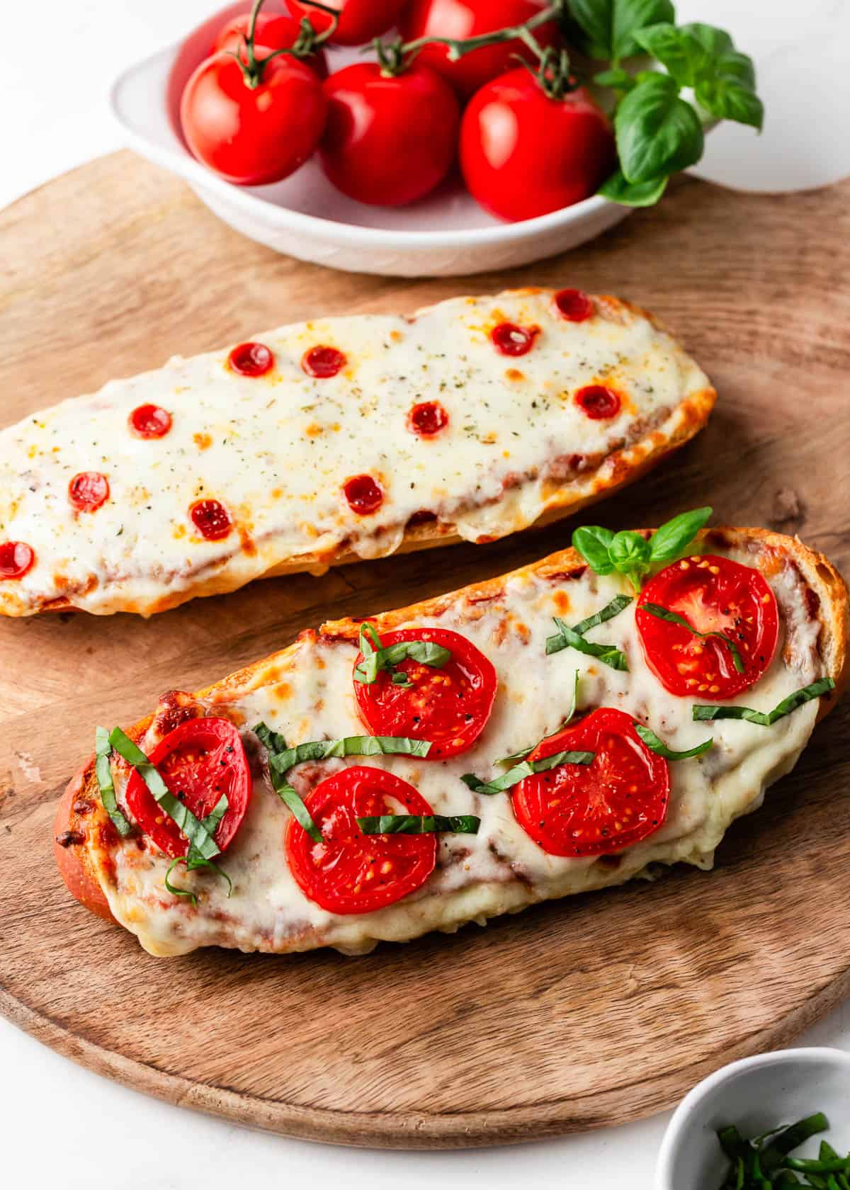 French bread pizza on a wooden board.