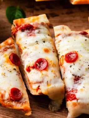 Sliced French bread pizza topped with melted cheese and pepperoni.