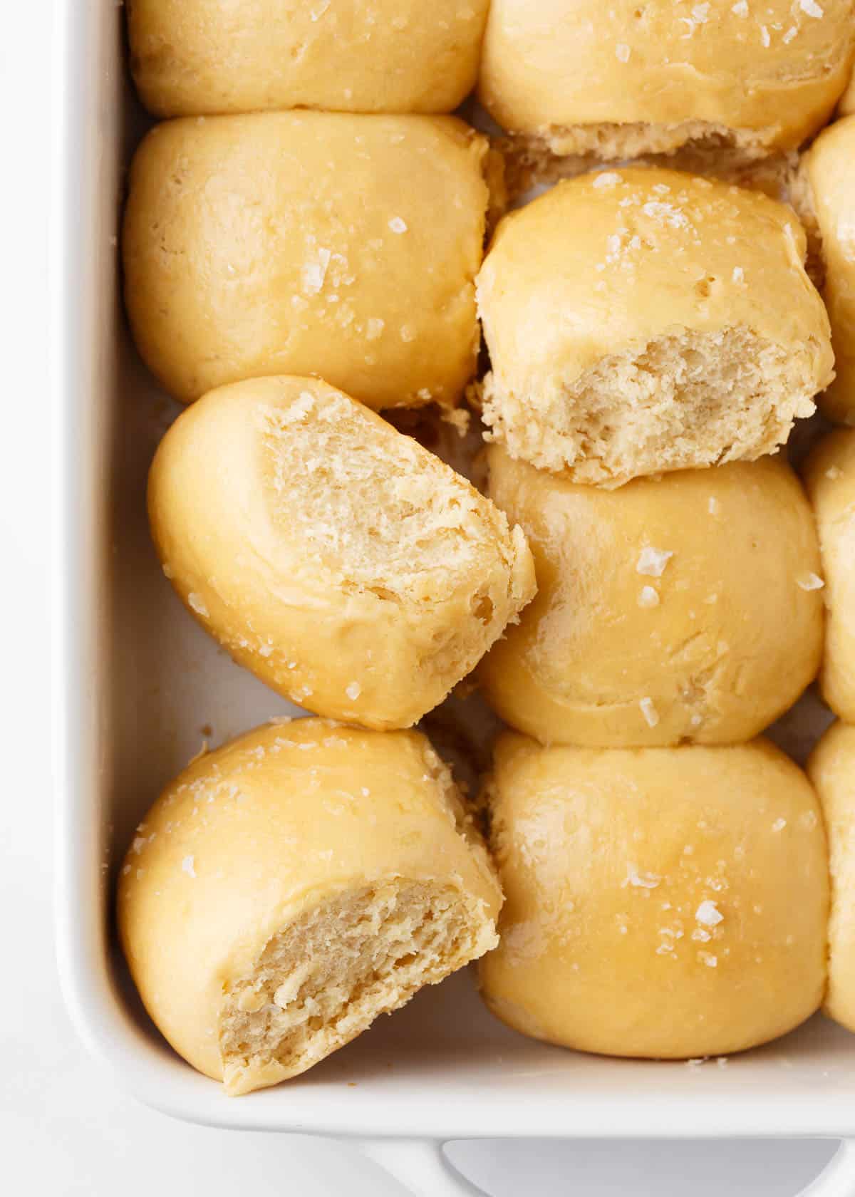 Hawaiian rolls in a white baking dish.