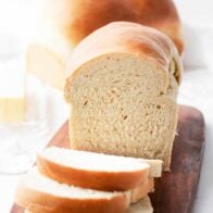 Sliced homemade bread on a cutting board.