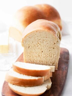 Sliced homemade bread on a cutting board.