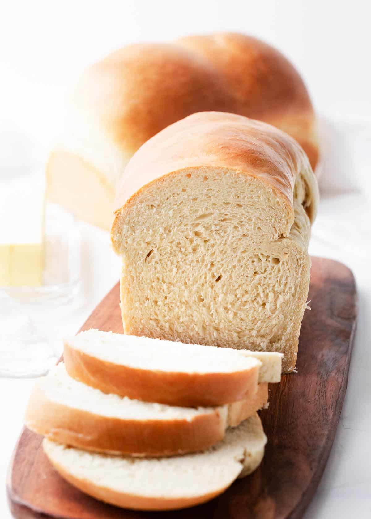 Sliced homemade bread on a cutting board.