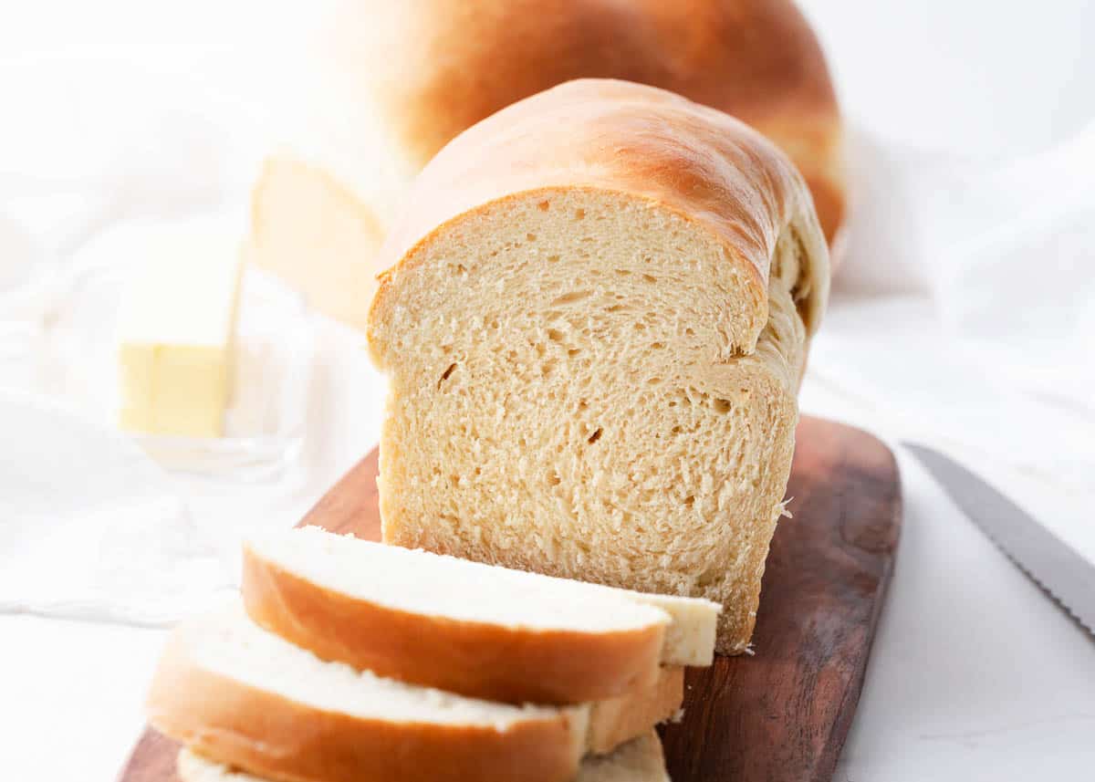 Sliced homemade bread on a board.