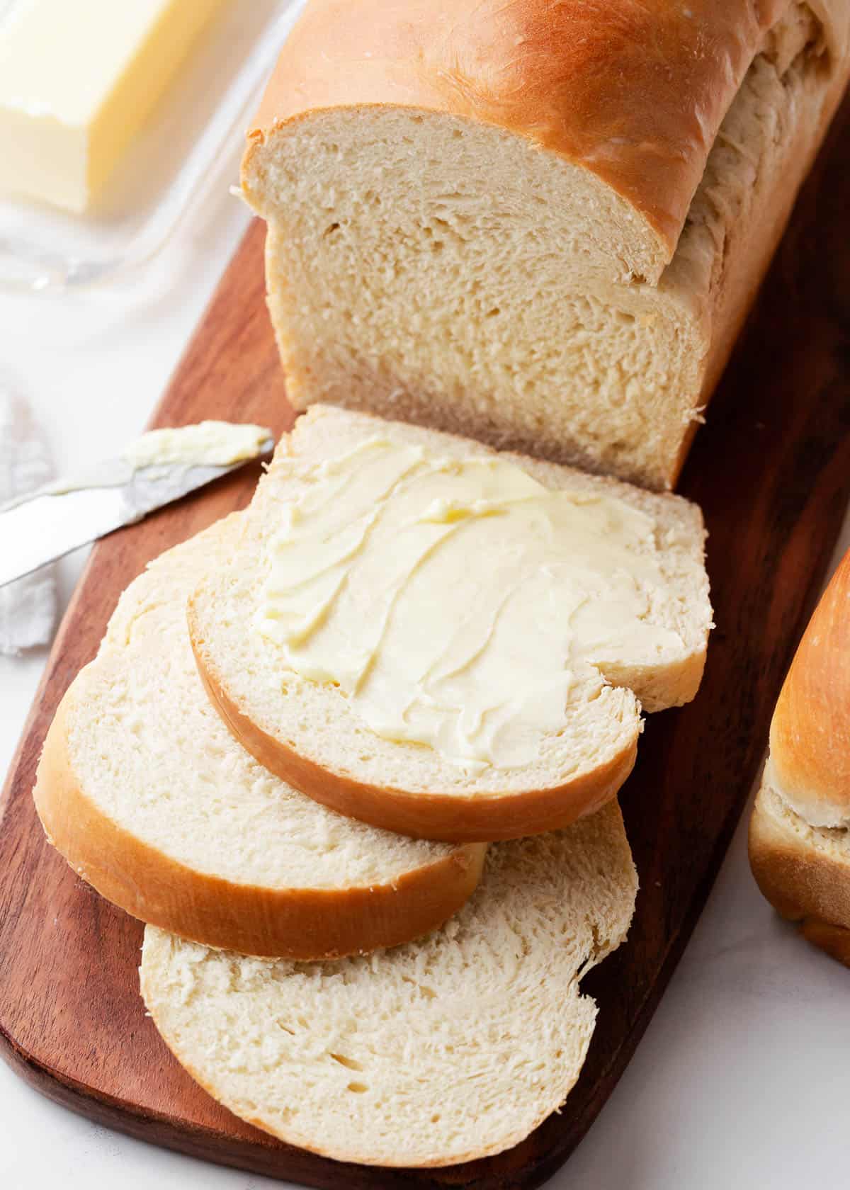 Sliced homemade bread on a wooden board.