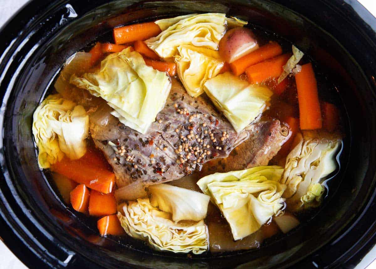Corned beef and cabbage cooking in crockpot.