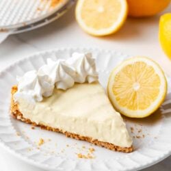 Slice of lemon icebox pie on a white plate.