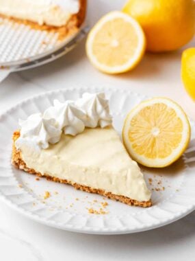 Slice of lemon icebox pie on a white plate.
