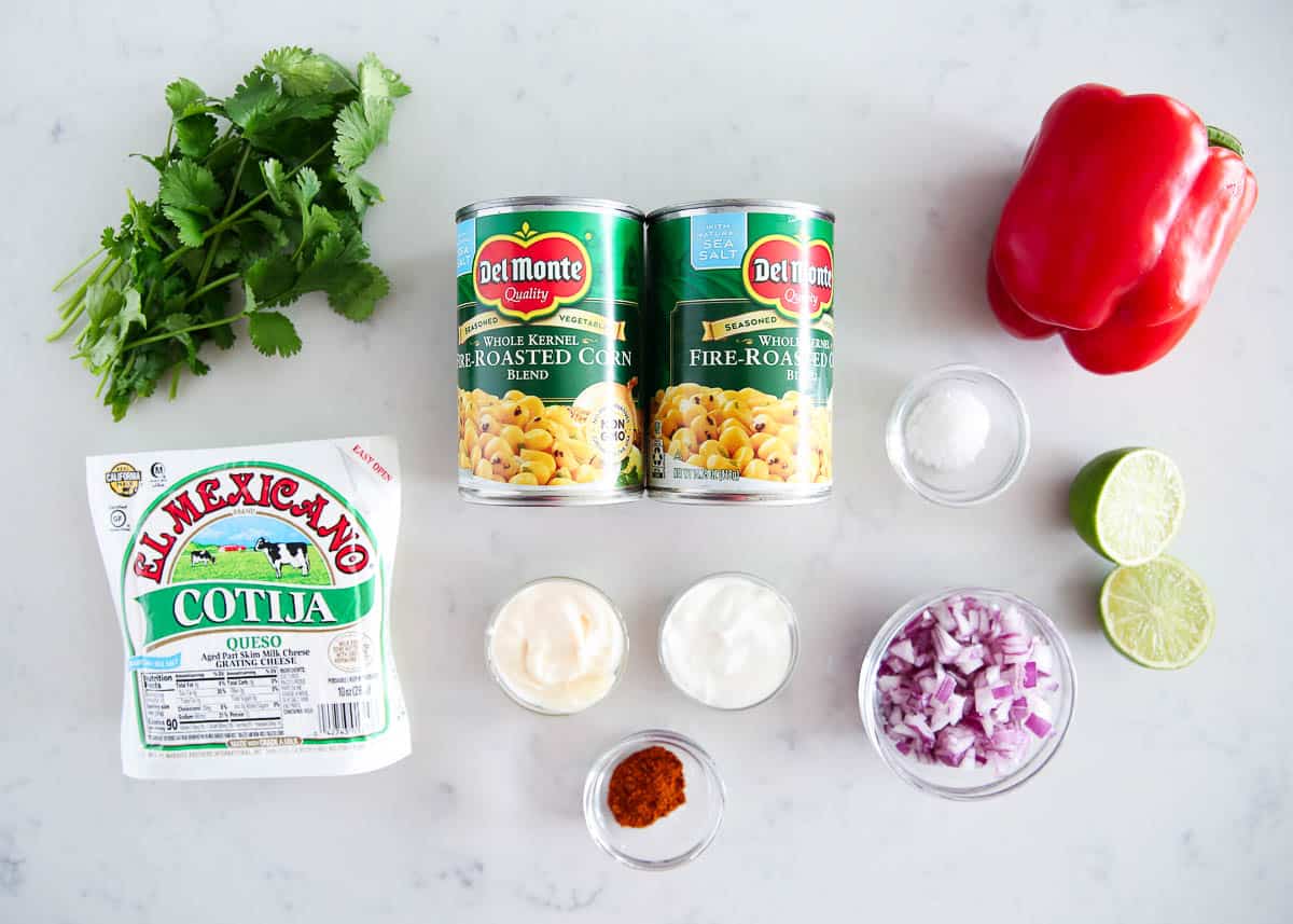 Mexican corn salad ingredients on counter.