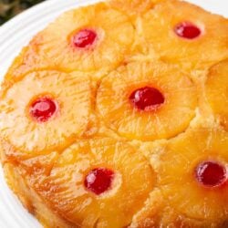 Pineapple upside down cake on white platter.