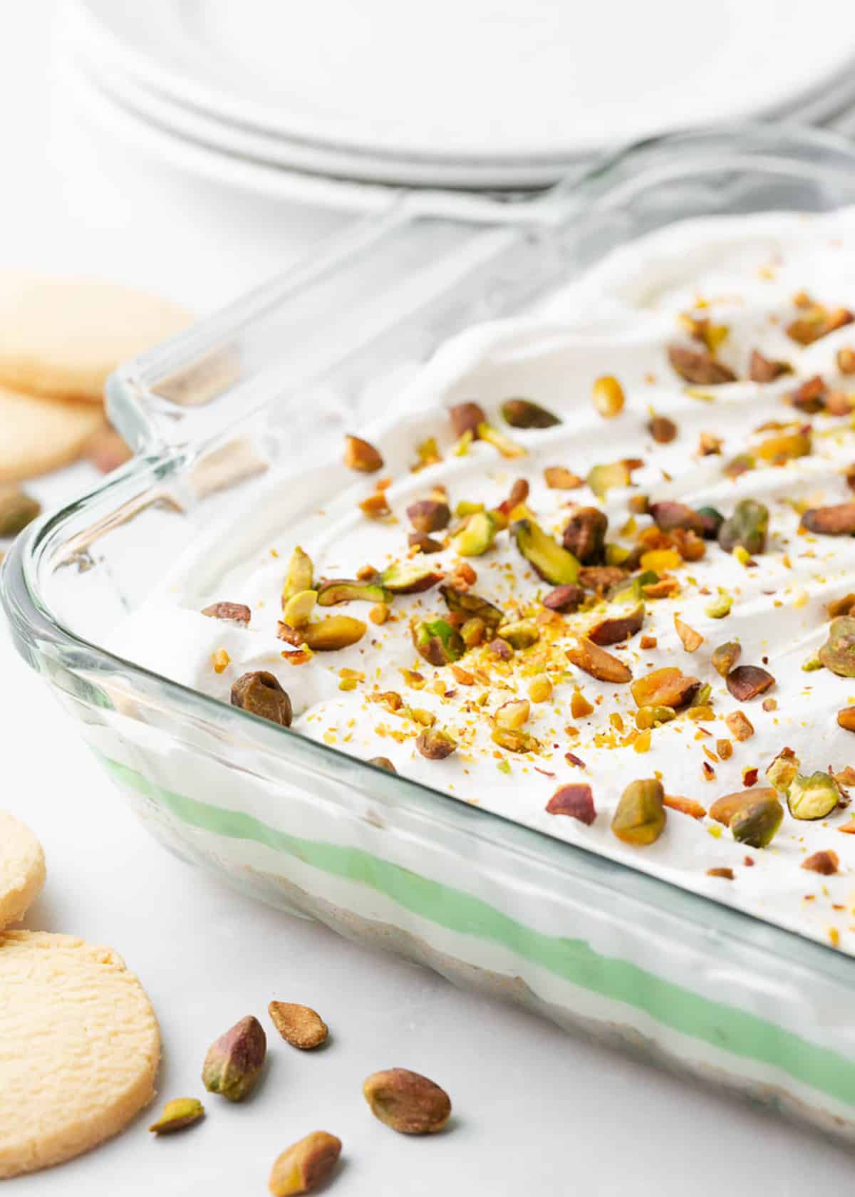 Layered pistachio dessert in a glass dish.