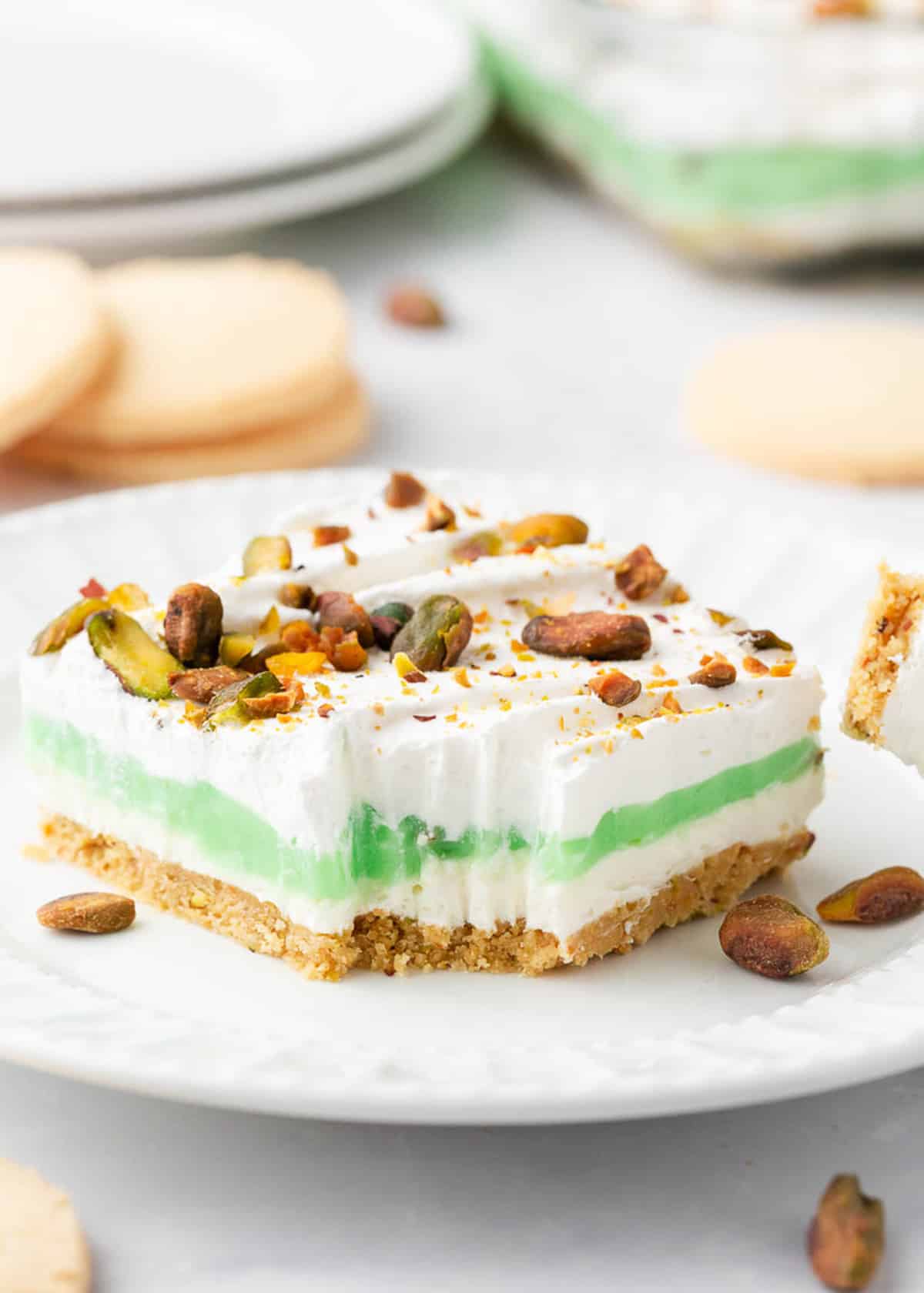 Layered pistachio dessert on plate.