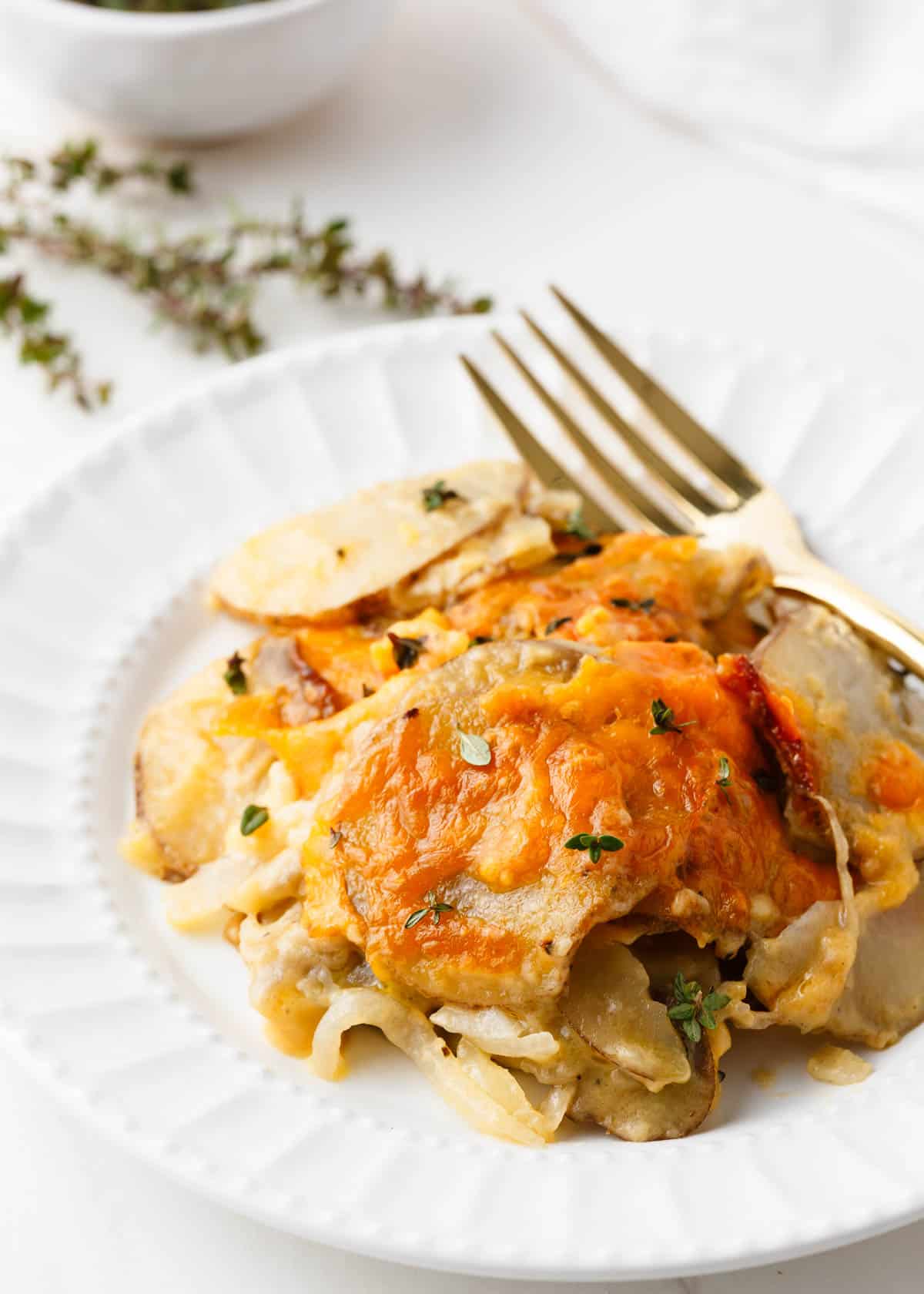 Potatoes au gratin on a white plate.