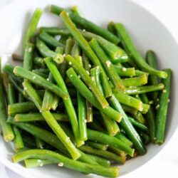Green beans in white bowl.