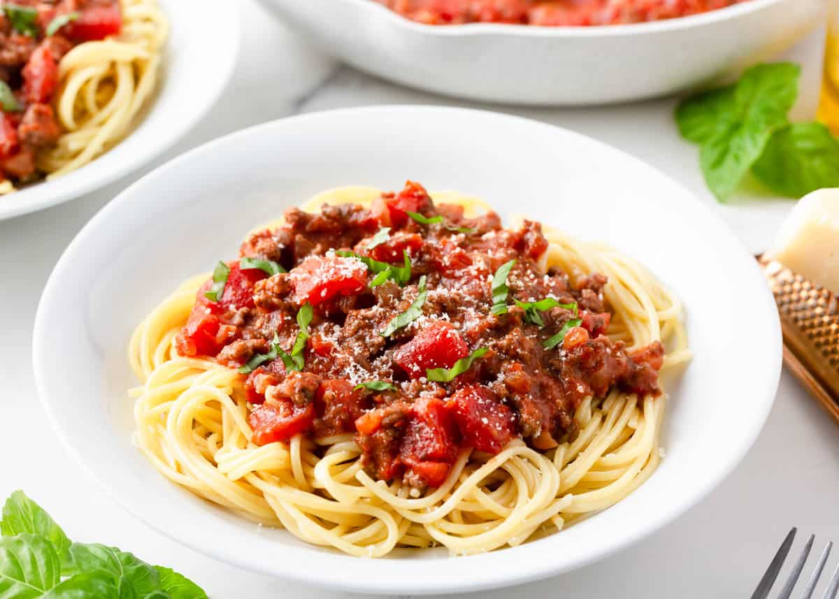 Spaghetti meat sauce in a white bowl.