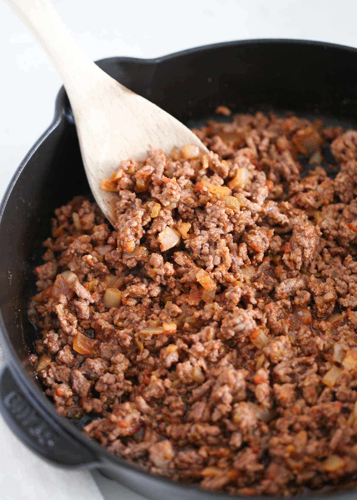 Taco meat cooking in a skillet.