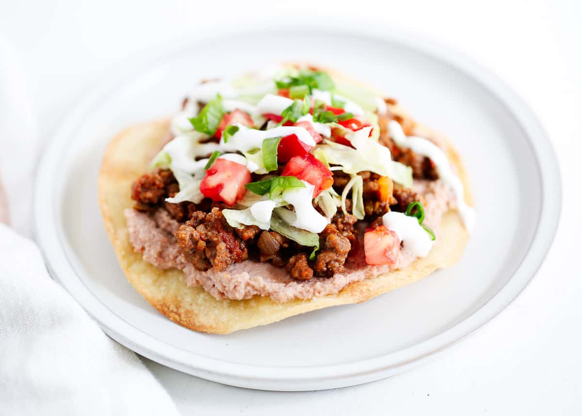 Tostada on a white plate.
