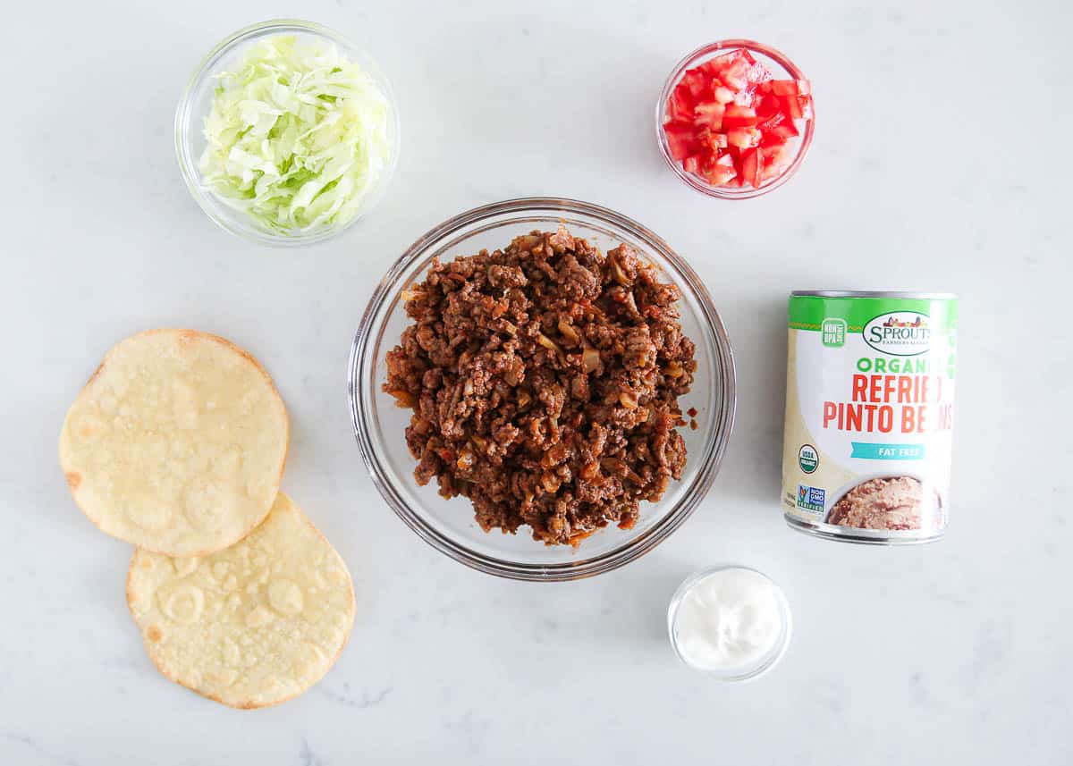 Tostada ingredients on marble countertop.