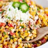 Mexican corn salad in a white bowl.
