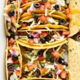 Ground beef tacos in a white baking dish.