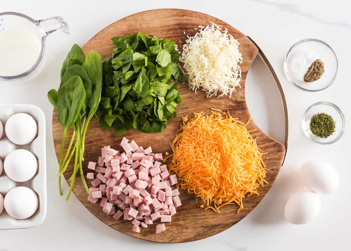 Crustless quiche ingredients on a wooden board. 