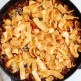 Frito pie cooked in a skillet.