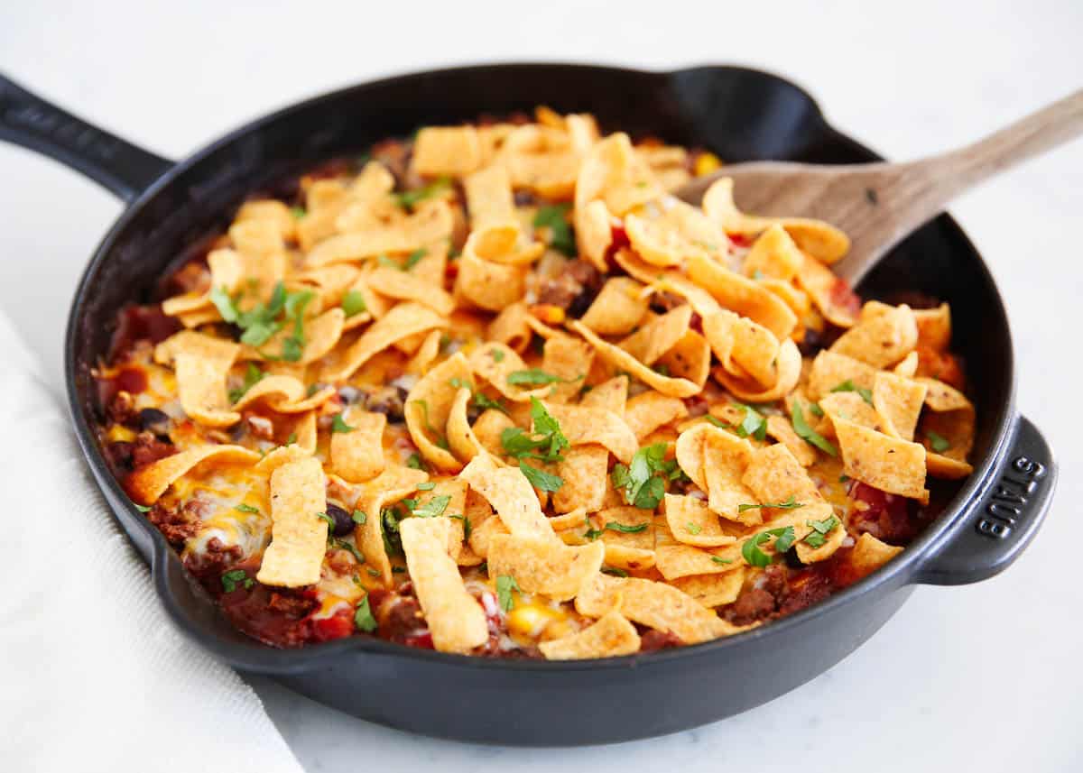 Frito pie in a black skillet.