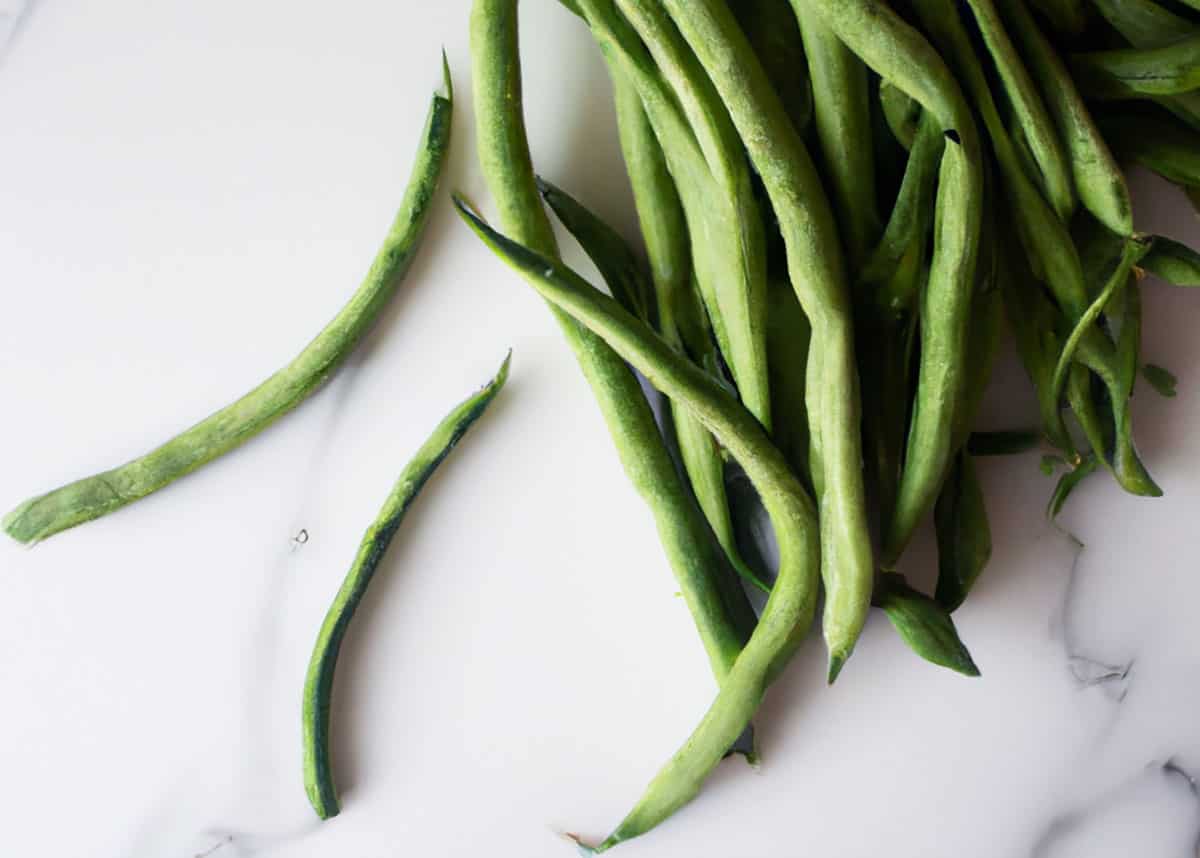 Green beans on marble counter.