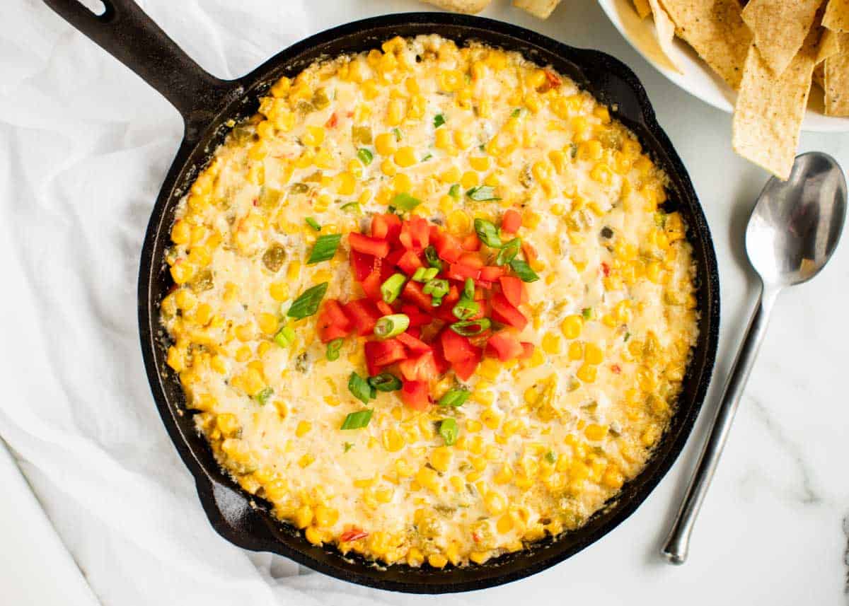 Corn dip in a cast iron skillet on counter.