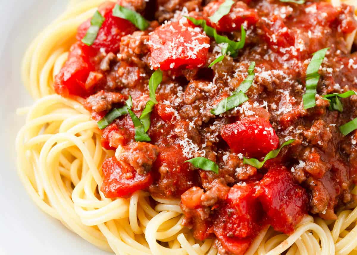 Spaghetti topped with homemade meat sauce, fresh basil, and parmesan cheese.