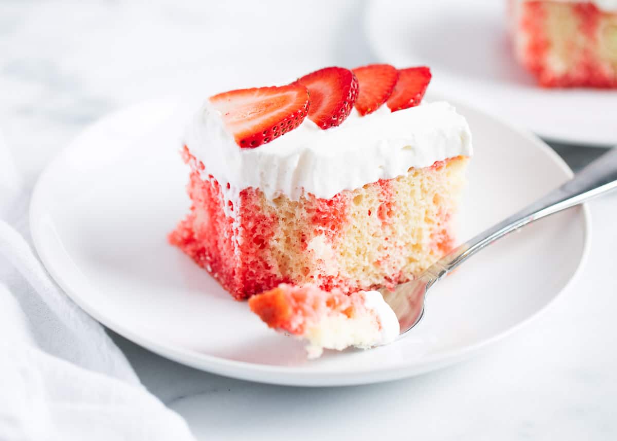 Jello poke cake with strawberries on top. 