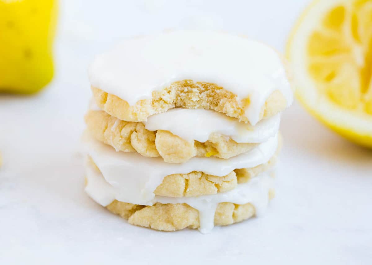 Glazed lemon cookies stacked on top of each other. 