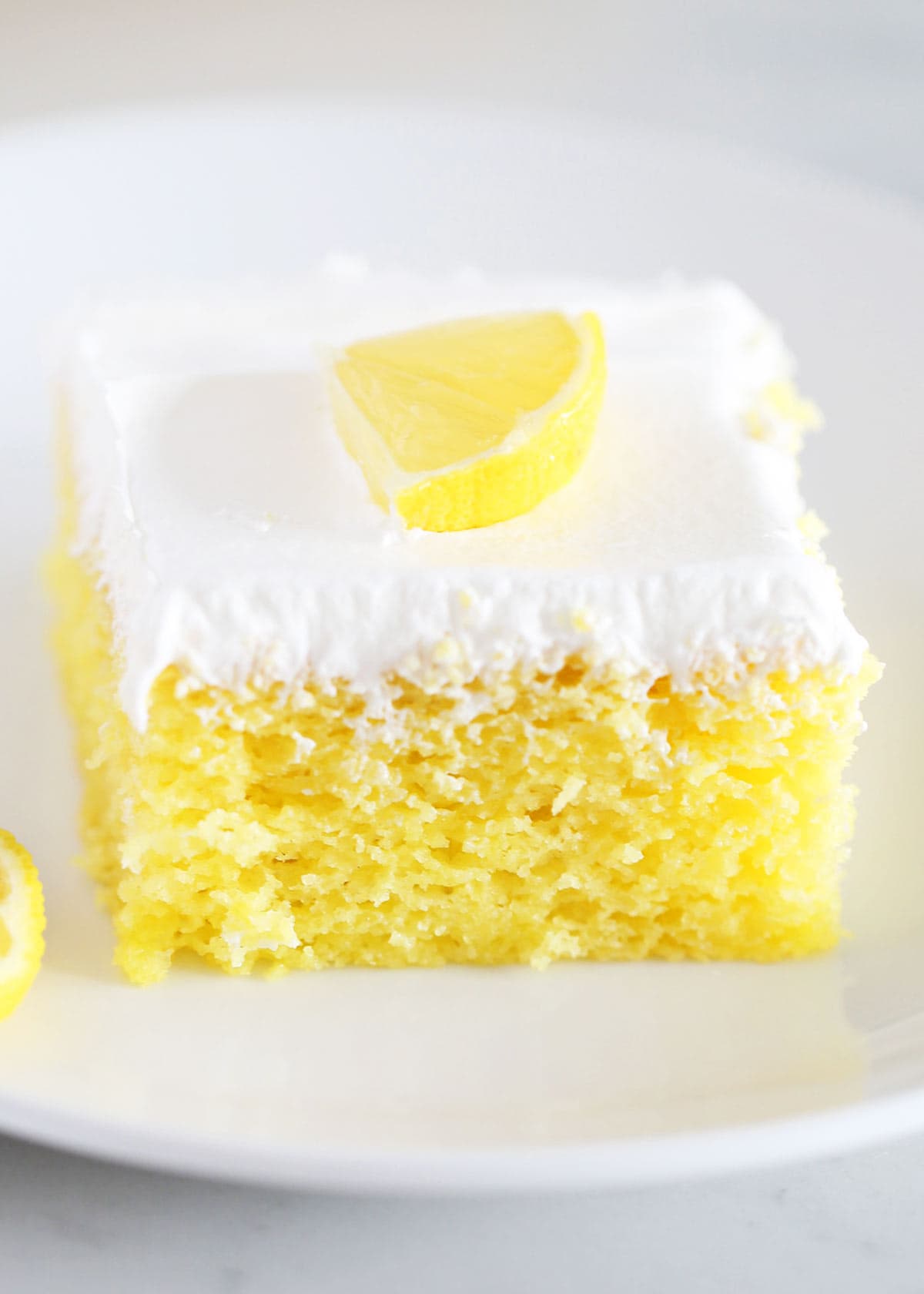 Slice of lemon poke cake.