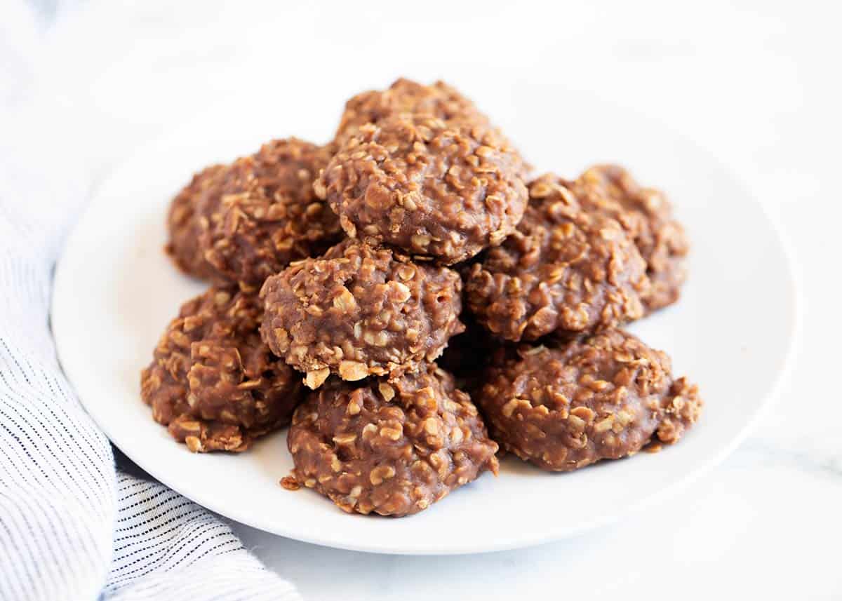 No-Bake Cookies - Only 7 ingredients and 15 minutes to make! Perfectly soft and chewy with a delicious chocolate peanut butter taste. No bake cookies on a white plate.