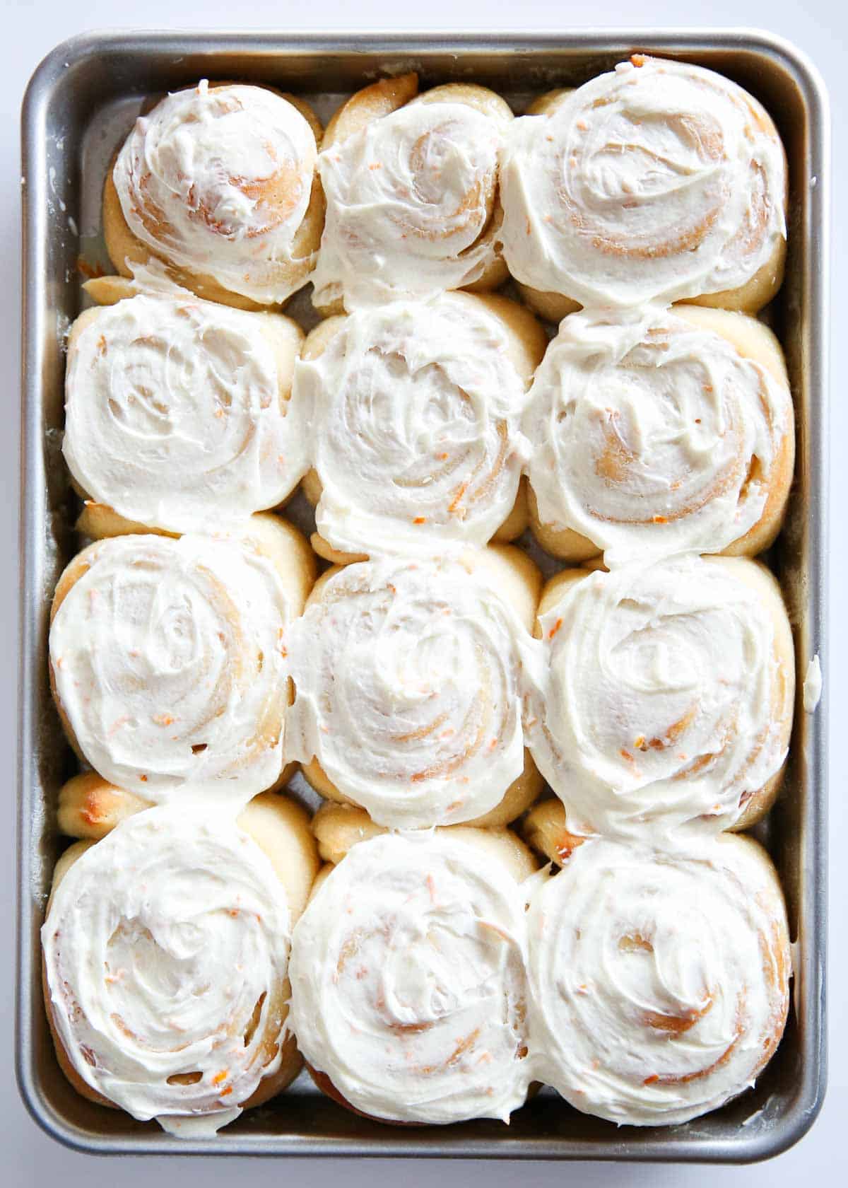 Orange rolls on a baking sheet. 