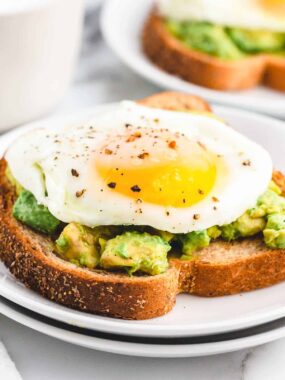 Sunny side up egg on avocado toast.