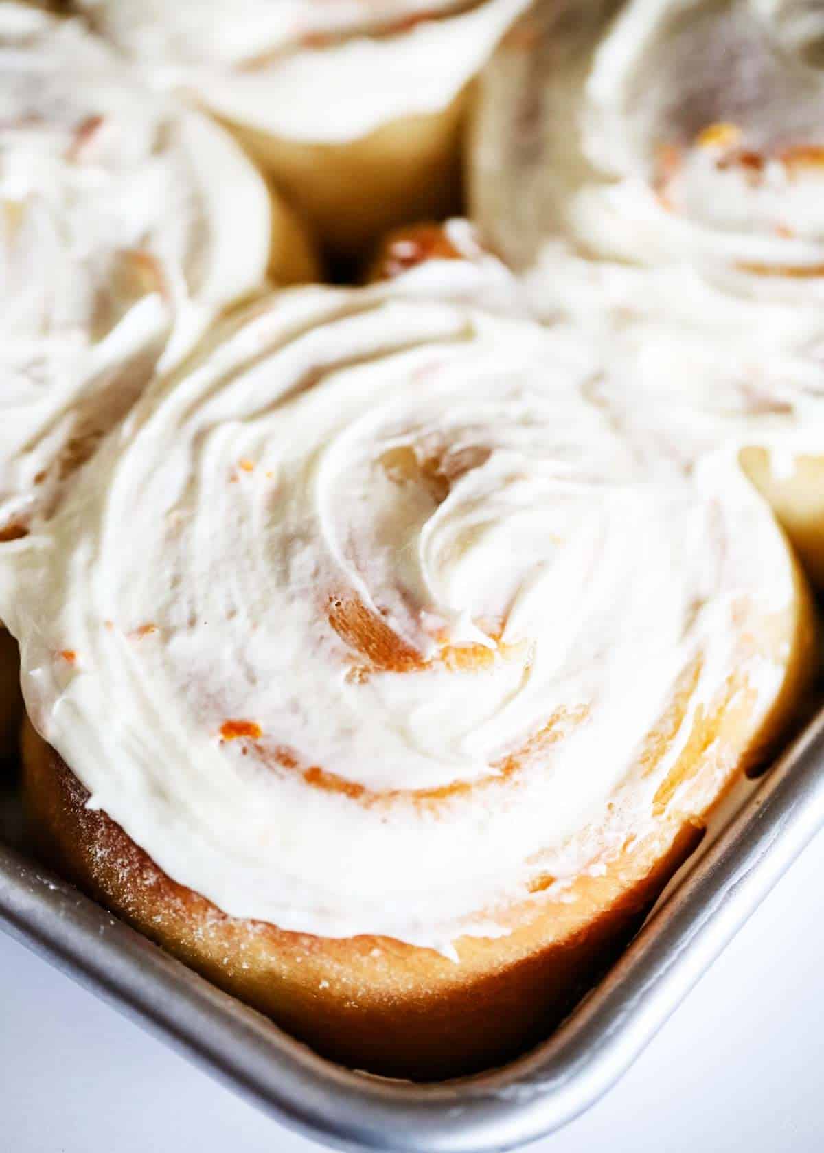 Up close photo of an orange roll. 